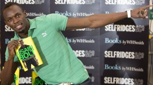 Jamaican athlete Usain Bolt poses for photographers with a copy of his autobiography, "Faster than Lightning,"  at Selfridges in central London